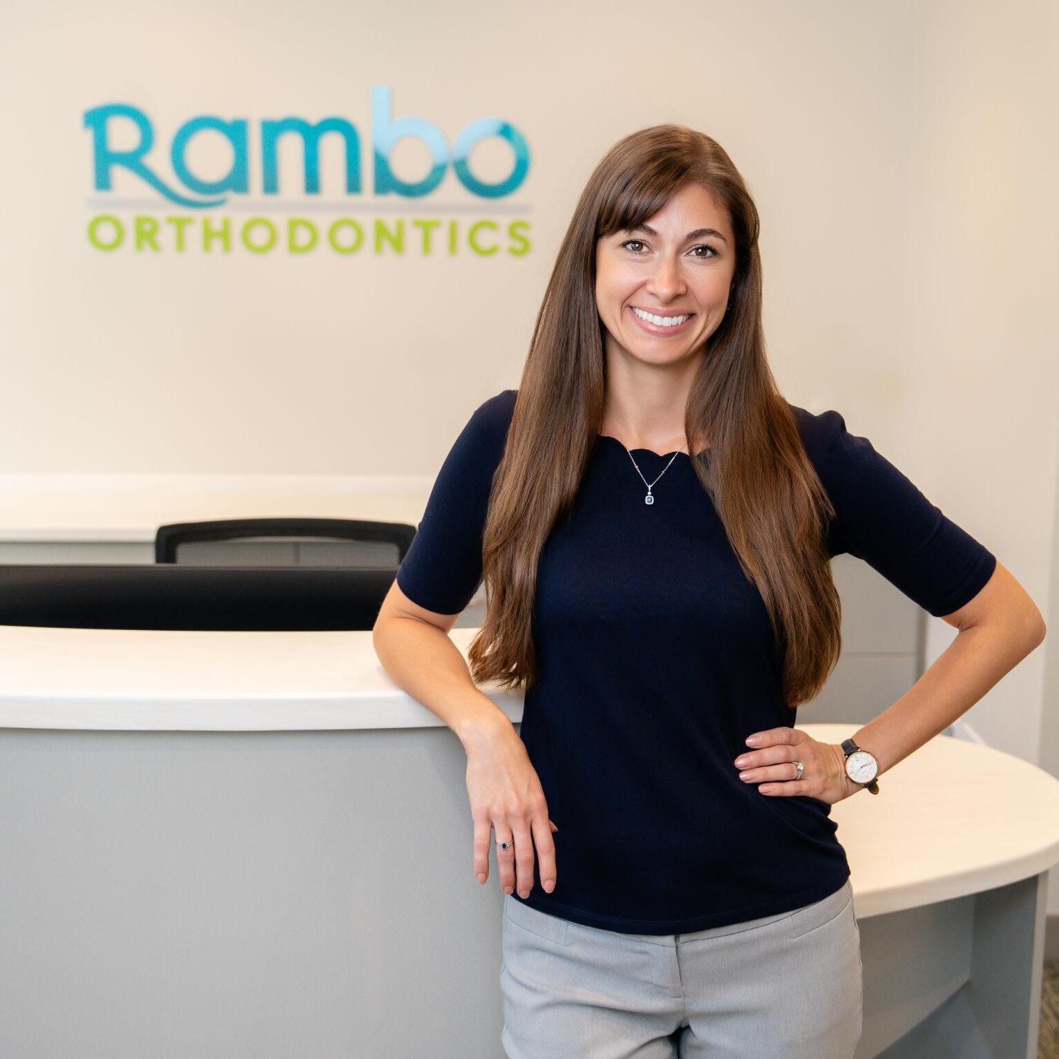 rambo-doctor-01816-02054 Dr. Lindsay Rambo smiling at Rambo Orthodontics reception, showcasing a welcoming environment for orthodontic care in Lansdale and Souderton.